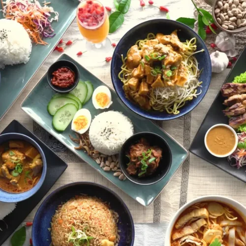 A vibrant spread of iconic Malaysian food dishes including rice and curries, featuring local cuisine experienced on a Malaysia Tour